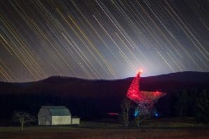 The Byrd Telescope glows red in the darkness at Green Bank.