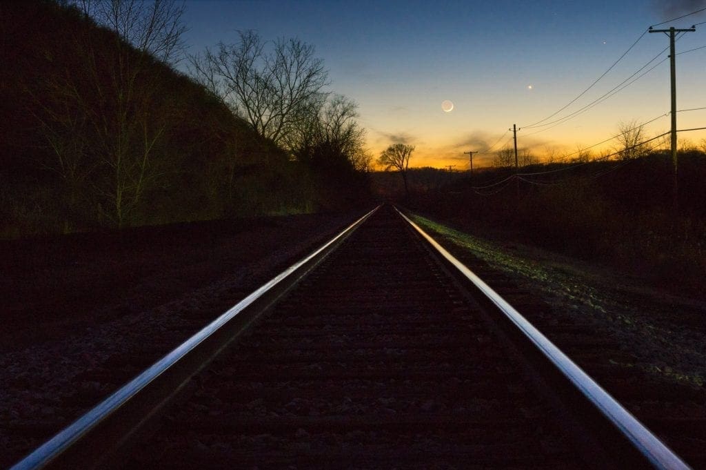 Mercury, Venus, and a waxing crescent moon rise above the valley of the Ohio River.