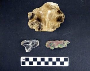 Artifacts from an Adena mound in Marshall County include mica (top), quartz (bottom left), and copper (bottom right). Courtesy Dept. of Arts, Culture, and History, Grave Creek Mound Archaeological Complex.