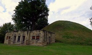 The Grave Creek Mound rises behind an early visitor center. Photo courtesy Charity Moore.
