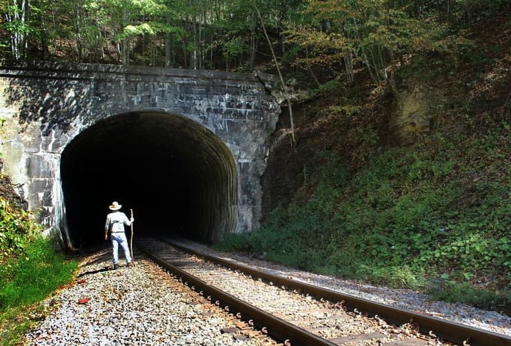 David Sibray peers into the Jenny Gap Tunnel near Lester, West Virginia, in Raleigh County.