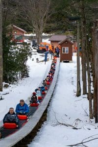 Sledders ride to the top of the run at Blackwater Falls State Park.