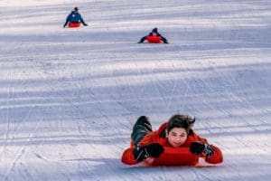 A young sledder barrels along the sled run at Blackwater Falls State Park.