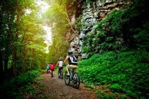 A family bikes a park trail in the New River Gorge National Park and Preserve.