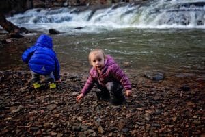 The Wolff children explore a pebbly beach along Paint Creek.