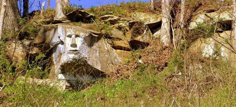 The rock face has been carved along a line f cliffs that crops out atop area hillsides.
