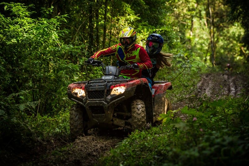 ATV riders navigate a muddy trail in the mountains of southern West Virginia.