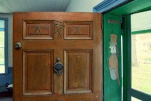 The image of a soldier appears in a threshold alongside mysterious slashes on a tavern door.