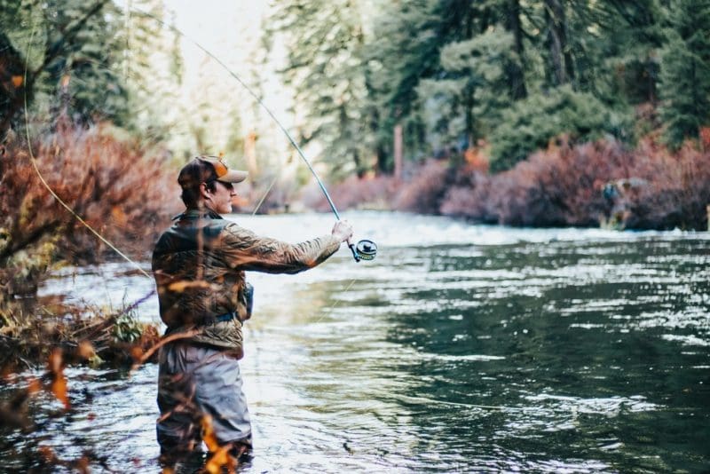 An angler casts into a river in the Monongahela National Forest.