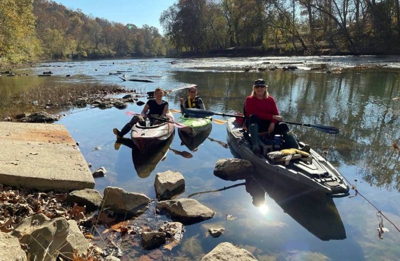 Members of the Trash-Your-Kayak Cleanup Crew paddle at a launch on a West Virginia stream.