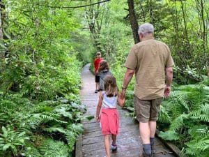 David Sibray accompanies a group of young protégés on a walk on the boardwalk at Cranberry Glades.
