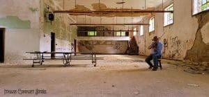 Sibray tests the acoustics in store's large main room in advance of the open house.