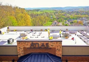A Solar Holler crew installs panels on the Atlas Building.