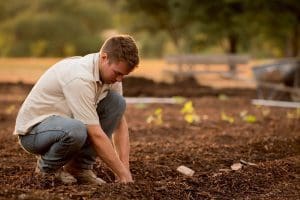 A farmer plants in a garden in West Virginia.