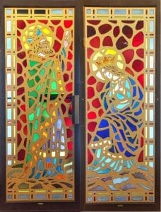 Light streams through stained glass windows at the American Glass Museum.