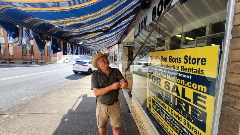 David Sibray rolls out an awning in advance of a July 29 open house at Mount Hope.