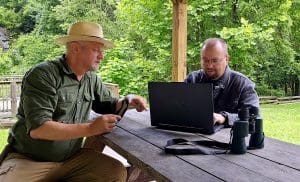 Founder David Sibray (left) and Technical Director Jonathan Moore review the addition of state parks information to WVExplorer.com.