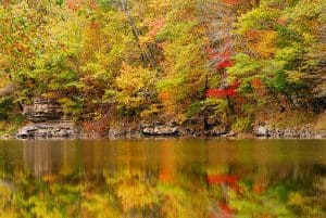 Autumn color reflects in a pool in the Bluestone National Scenic River.