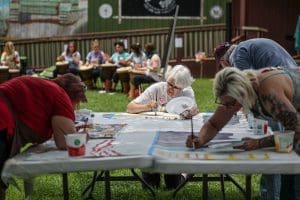 Participants in the Create Your State Convening work together on a mural in Princeton, West Virginia.