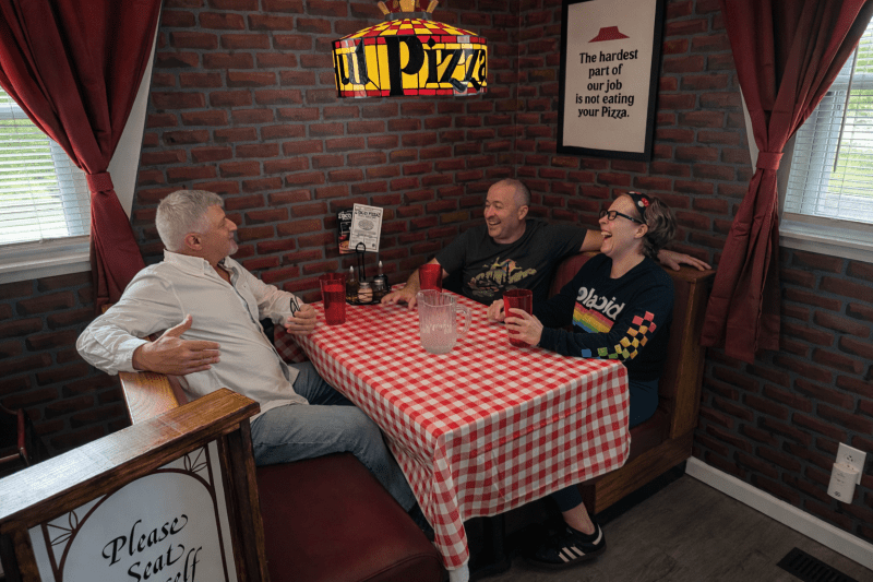 Appalachian Escapes: Straight out of the ’80s: David Sibray, Nate Adams, and Rachel Adkins swap stories in a replica Pizza Hut. (Photo: Holly K. Clark)