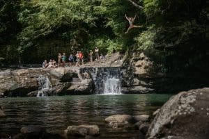 A swimmer leaps from a cliff on Glade Creek in Raleigh County. Photo: Jay Young (IronArchMedia.com)